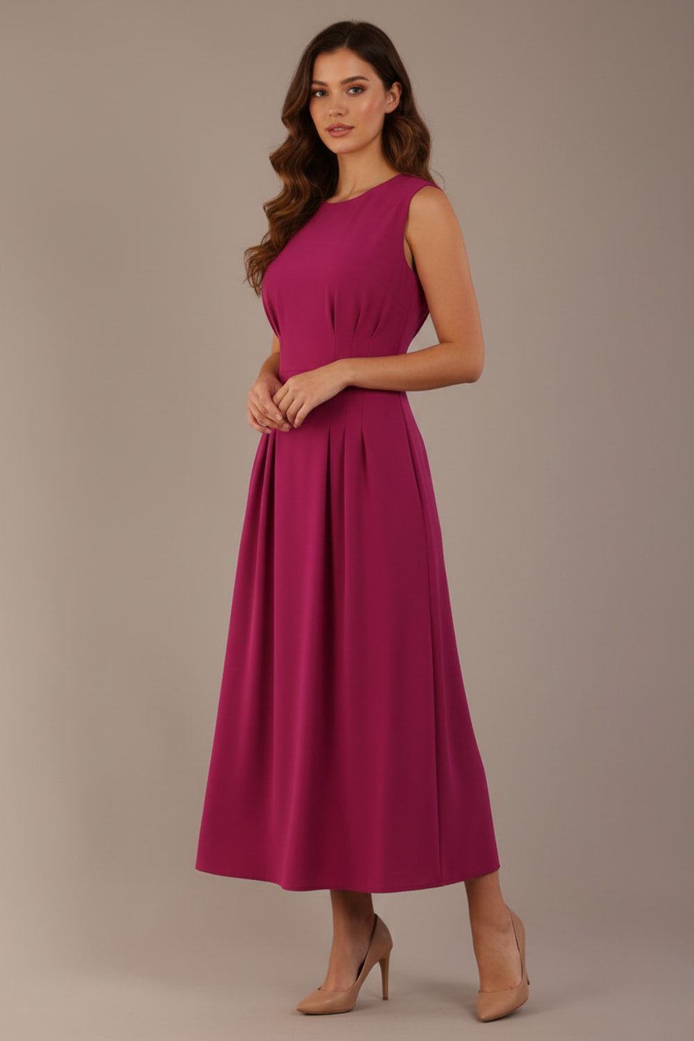 Model wearing the Cleo pleated midaxi dress in magenta with discreet side pockets (Magenta)