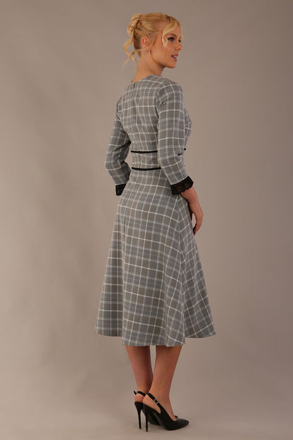 Model wearing the Hendricks check midi dress in misty grey with black lace cuffs and a V-neck (Misty Grey Check)