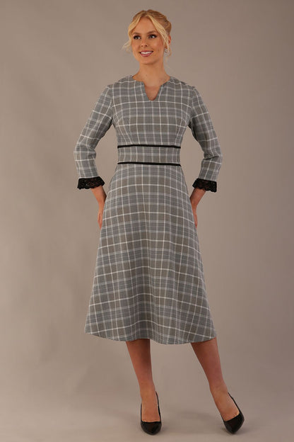 Model wearing the Hendricks check midi dress in misty grey with black lace cuffs and a V-neck (Misty Grey Check)