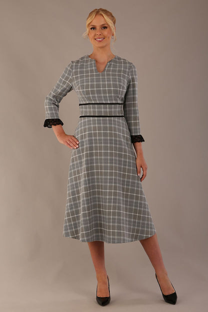 Model wearing the Hendricks check midi dress in misty grey with black lace cuffs and a V-neck (Misty Grey Check)