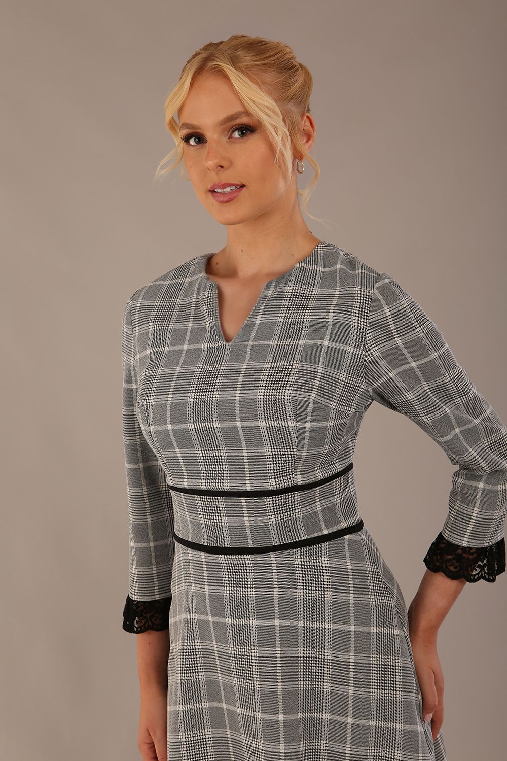 Model wearing the Hendricks check midi dress in misty grey with black lace cuffs and a V-neck (Misty Grey Check)