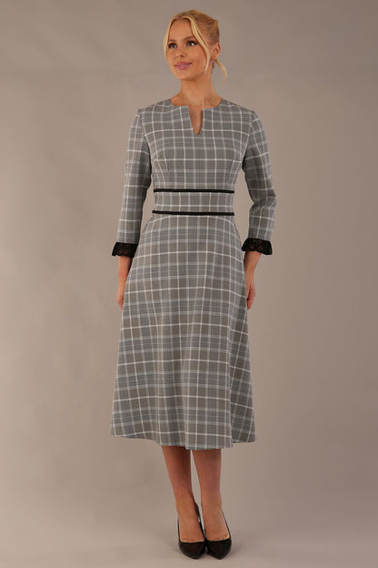 Model wearing the Hendricks check midi dress in misty grey with black lace cuffs and a V-neck (Misty Grey Check)