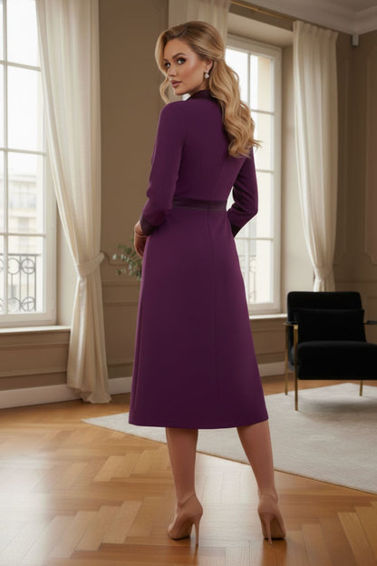 Model wearing the Sybil A-line midi dress in imperial purple with a satin cowl neck and waistband. (Imperial Purple)