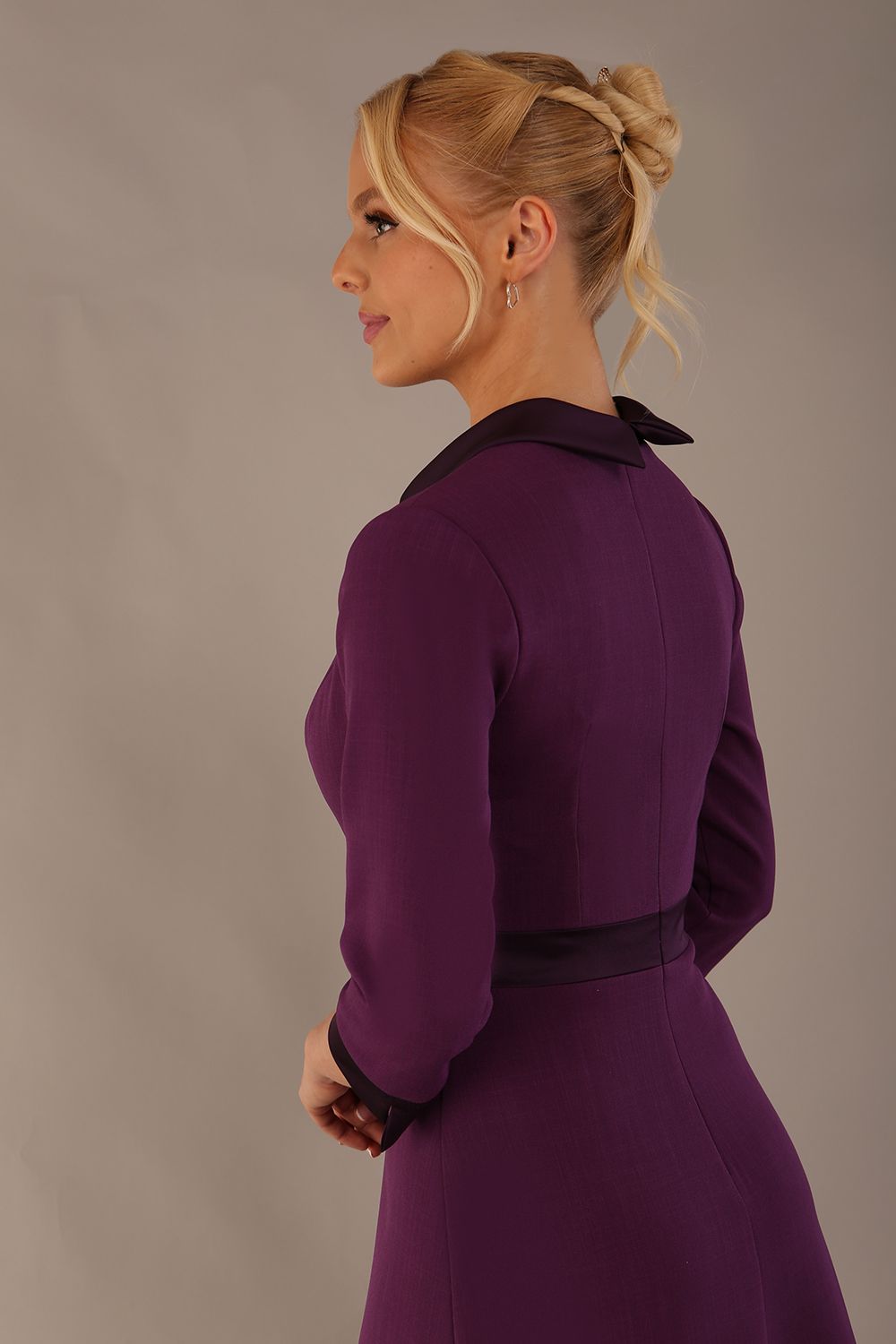 Model wearing the Sybil A-line midi dress in imperial purple with a satin cowl neck and waistband. (Imperial Purple)