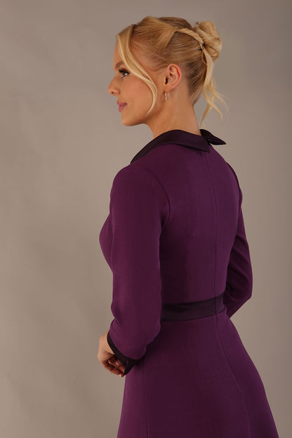 Model wearing the Sybil A-line midi dress in imperial purple with a satin cowl neck and waistband. (Imperial Purple)