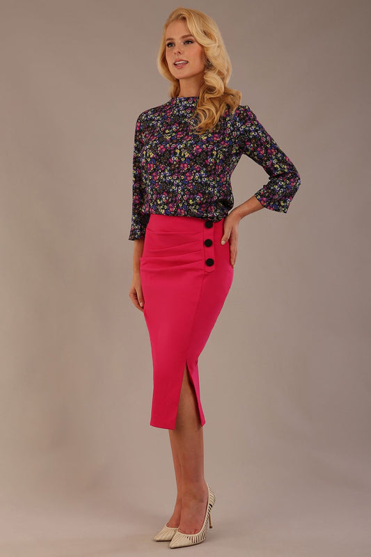 Blonde model wearing a fuchsia pink Claudette pencil skirt, showing the profile view with side buttons (Fuchsia Pink)