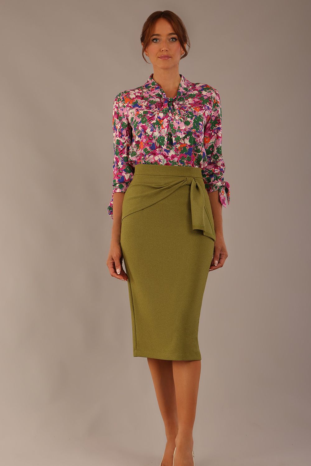 Model wearing a Radley Floral Tango print top with a central tie neckline and 3/4 sleeves, styled with an olive green skirt (Floral Tango)