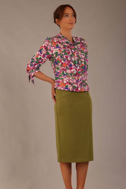 Model wearing a Radley Floral Tango print top with a central tie neckline and 3/4 sleeves, styled with an olive green skirt (Floral Tango)