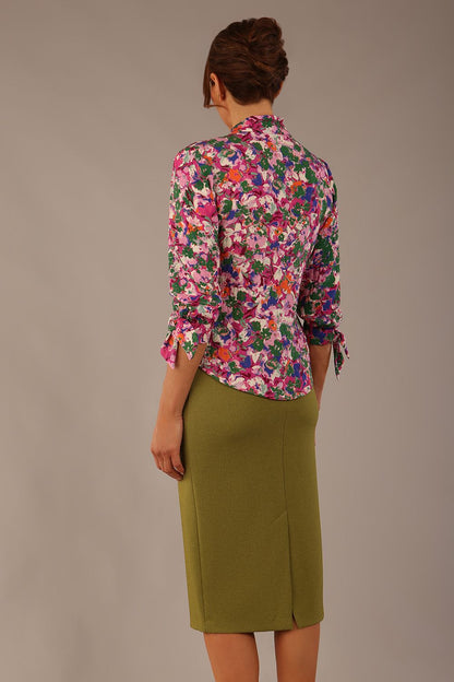 Model wearing a Radley Floral Tango print top with a central tie neckline and 3/4 sleeves, styled with an olive green skirt (Floral Tango)