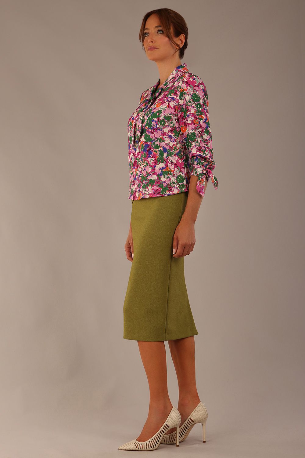Model wearing a Radley Floral Tango print top with a central tie neckline and 3/4 sleeves, styled with an olive green skirt (Floral Tango)