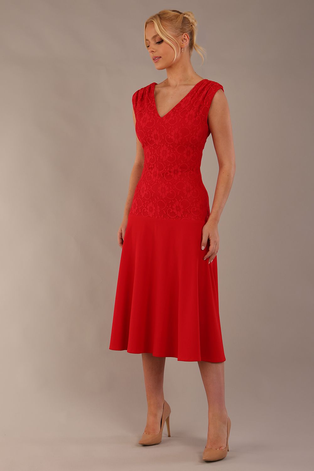 Woman wearing the Ayesha lace A-line midi dress in vibrant passion red against a neutral background (Passion Red)