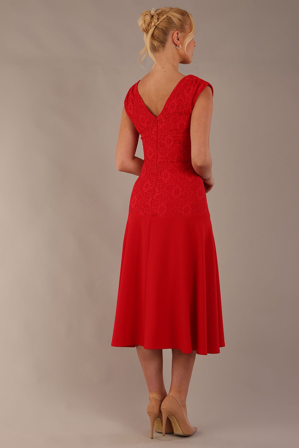 Woman wearing the Ayesha lace A-line midi dress in vibrant passion red against a neutral background (Passion Red)