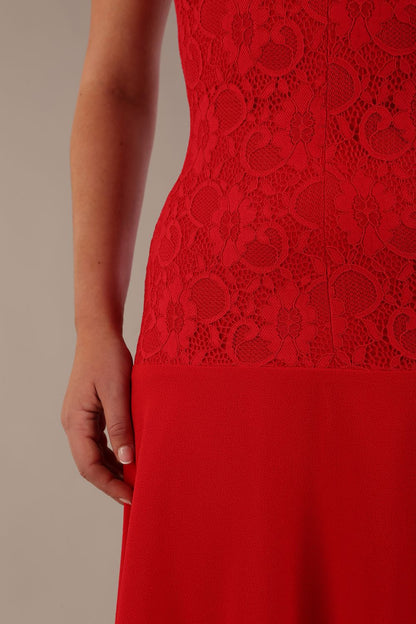 Woman wearing the Ayesha lace A-line midi dress in vibrant passion red against a neutral background (Passion Red)