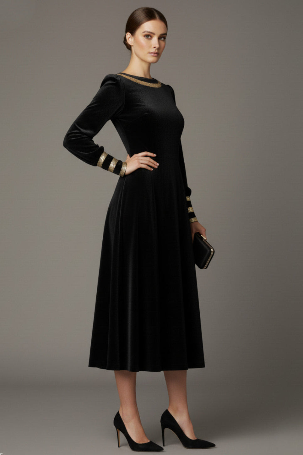 Woman wearing a black dress with gold accents sitting on a stool against a beige background (Black Velvet with Sherwood Glitter Contrast)