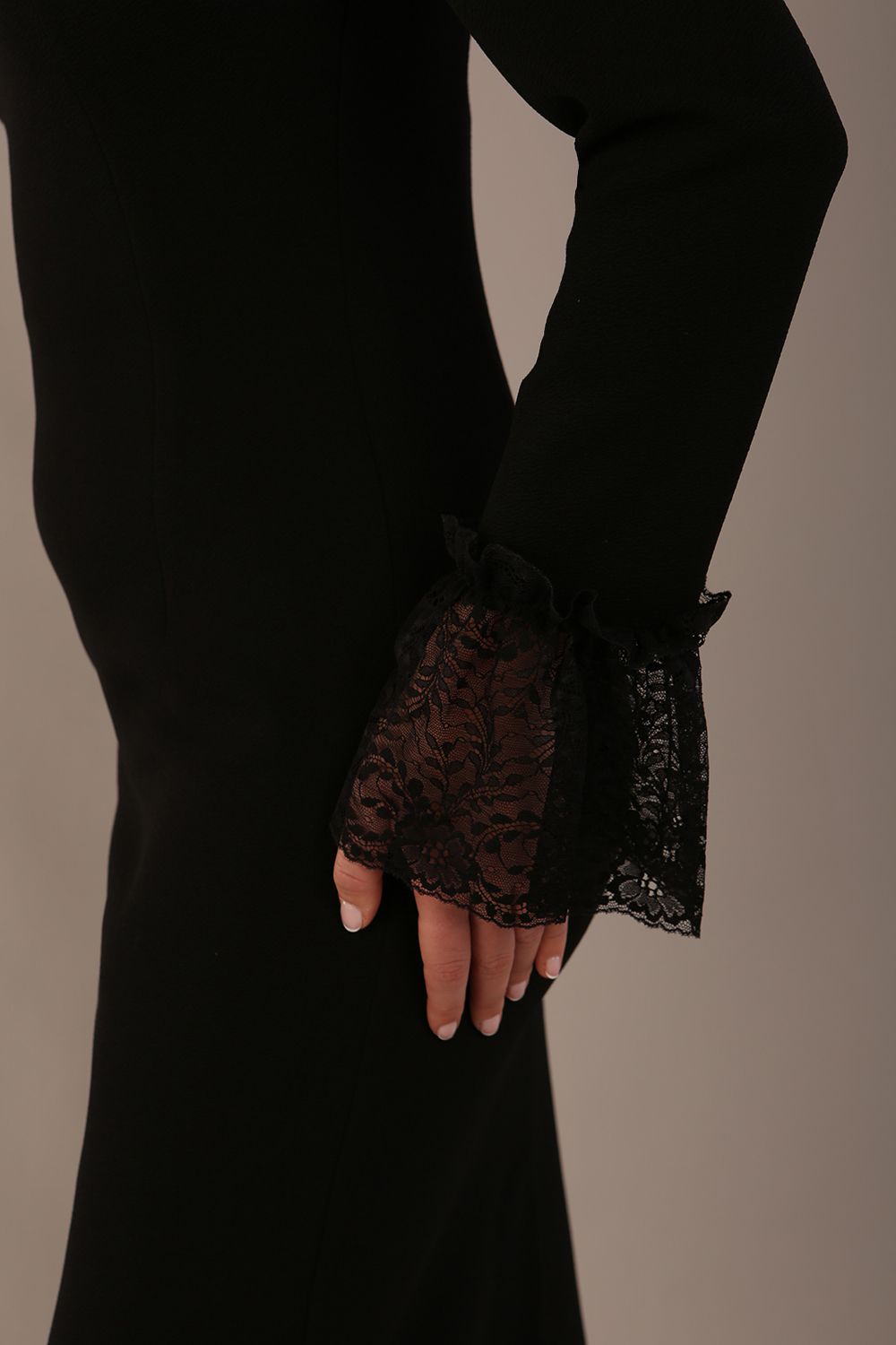 Model wearing the Holby fluted lace cuff pencil dress in black. (Black)