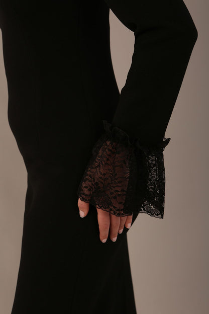 Model wearing the Holby fluted lace cuff pencil dress in black. (Black)