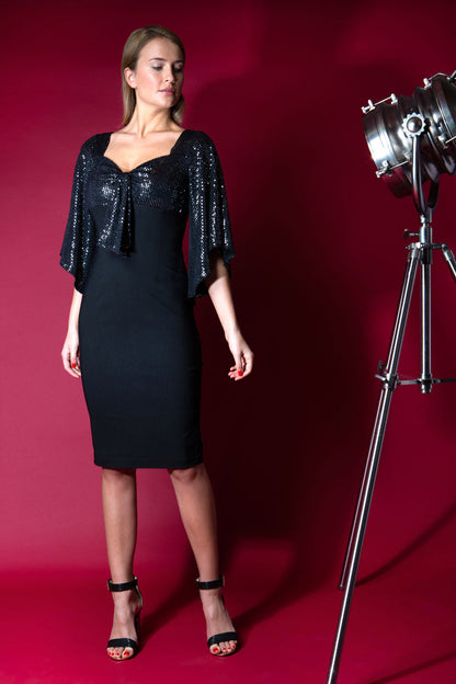 blonde model is wearing diva catwalk premiere pencil vintage sperkly dress with sleeves and empire waist in black front