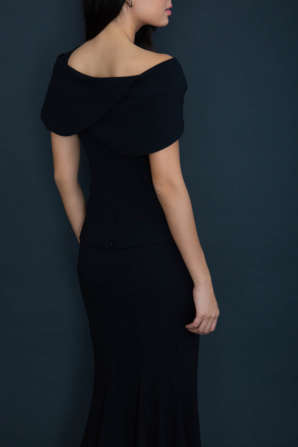 model wearing diva catwalk asymmetric neckline black short sleeve top back