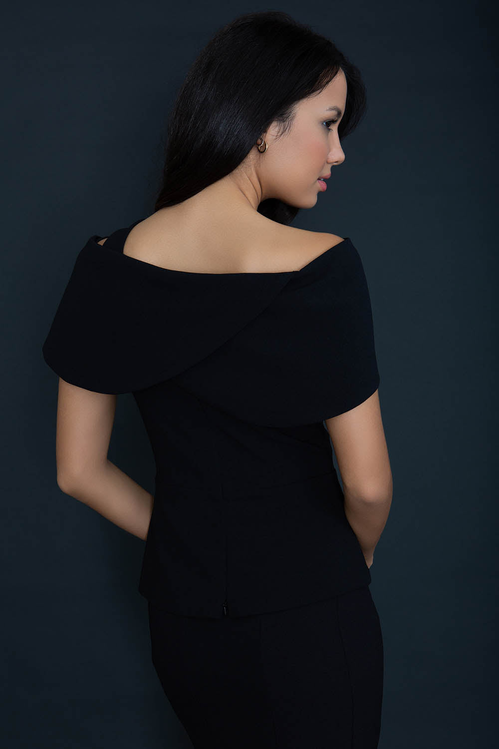 model wearing diva catwalk asymmetric neckline black short sleeve top back