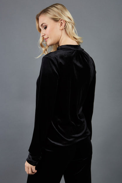 blonde model is wearing diva catwalk allium velvet sleeved high neck top in colour black front