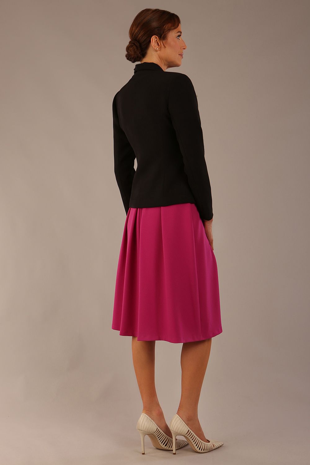 back view of the Model wearing the Melberry tailored jacket in black, showing the sculpted waist and statement lapel detail (Black)