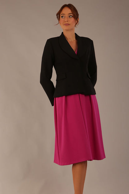 Model wearing the Melberry tailored jacket in black, showing the sculpted waist and statement lapel detail (Black)