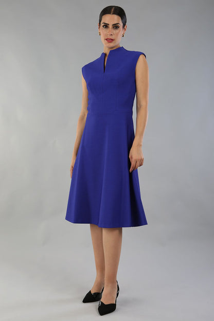 Brunette Model is wearing a sleeveless swing high neck dress with high neck in palace blue by Diva Catwalk front