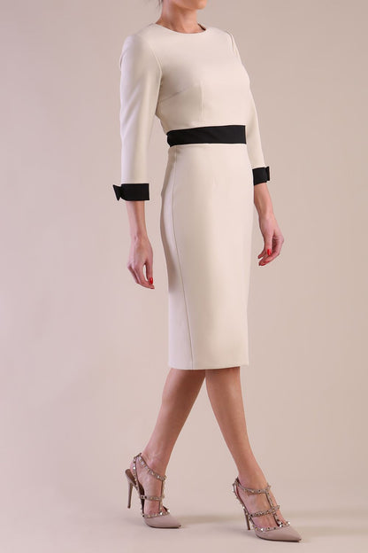Back Image of Model wearing diva catwalk Reese 3/4 Sleeved pencil skirt dress with a contrast sleeve and waistband details in Sandshell Beige/Black