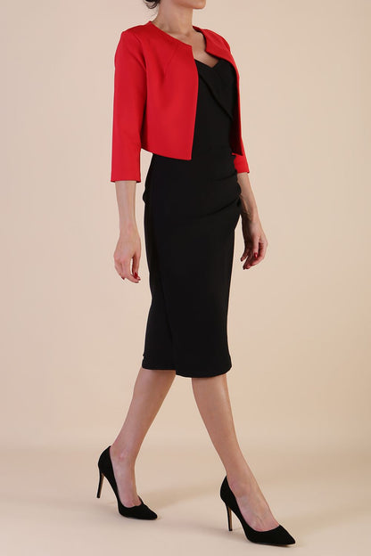 brunette model wearing diva catwalk red sleeved bolero over a printed pencil dress front