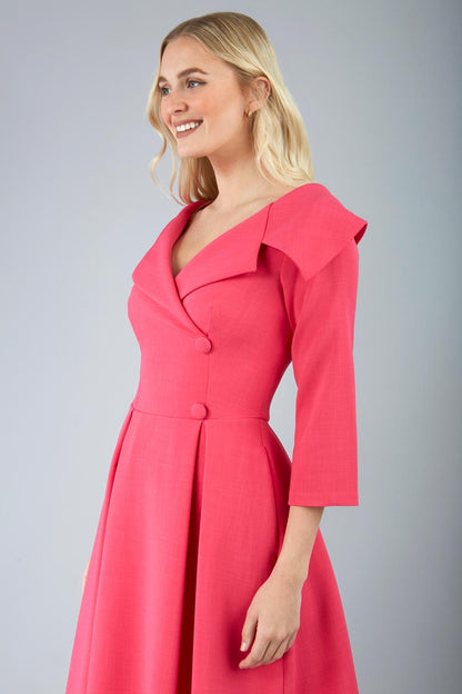 model is wearing diva catwalk gatsby swing dress with pocket detail and wide v-neck collar and buttons down the front panel in hibiscus pink front