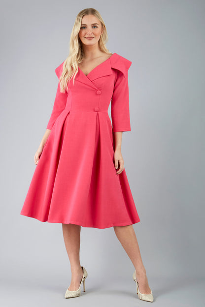 model is wearing diva catwalk gatsby swing dress with pocket detail and wide v-neck collar and buttons down the front panel in hibiscus pink front