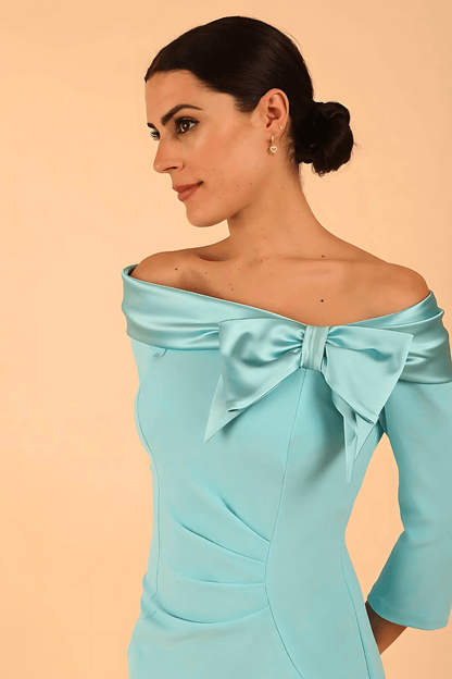 Model is wearing a diva catwalk Rosalind Off Shoulder Bow Detail Pencil Dress 3/4 sleeve in Turquoise contrast front image (Turquoise)