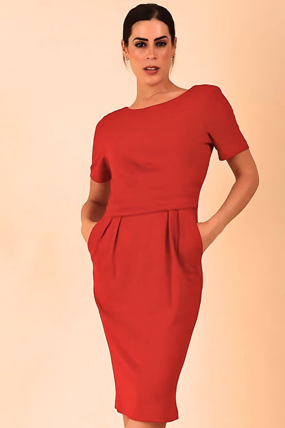 Brunette model is wearing marcel stretch short sleeve pencil dress image in tango red colour