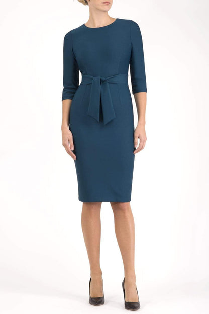 Model wearing the Diva Amatis Pencil dress with round neckline, inserted tie detailing at the front in glorious teal front image