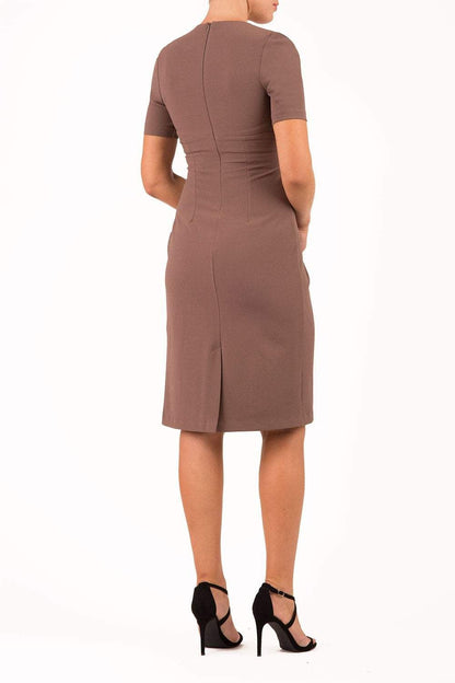 brunette model wearing diva catwalk tregony a-line dress with lowered v-neckline in brown and short sleeves front