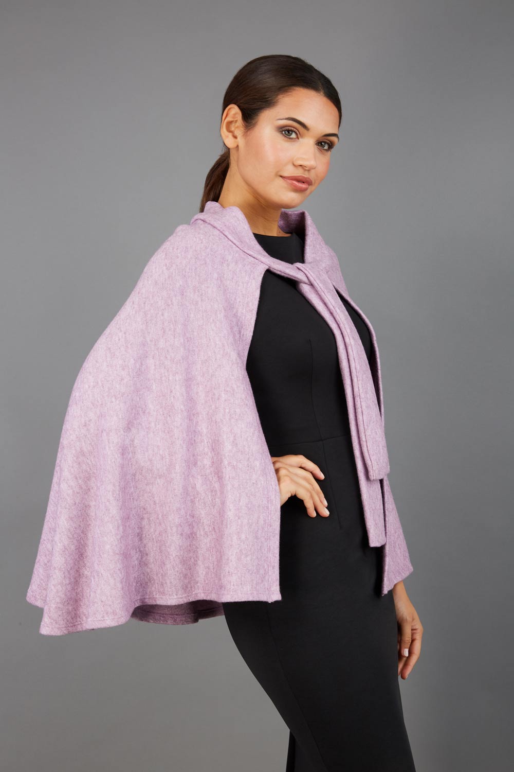 brunette model wearing diva catwalk hampstead cape known as shawl high neck in pink front