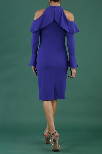 brunette model is wearing diva catwalk liah long sleeve cold-shoulder pencil dress with high neck in spectrum indigo front