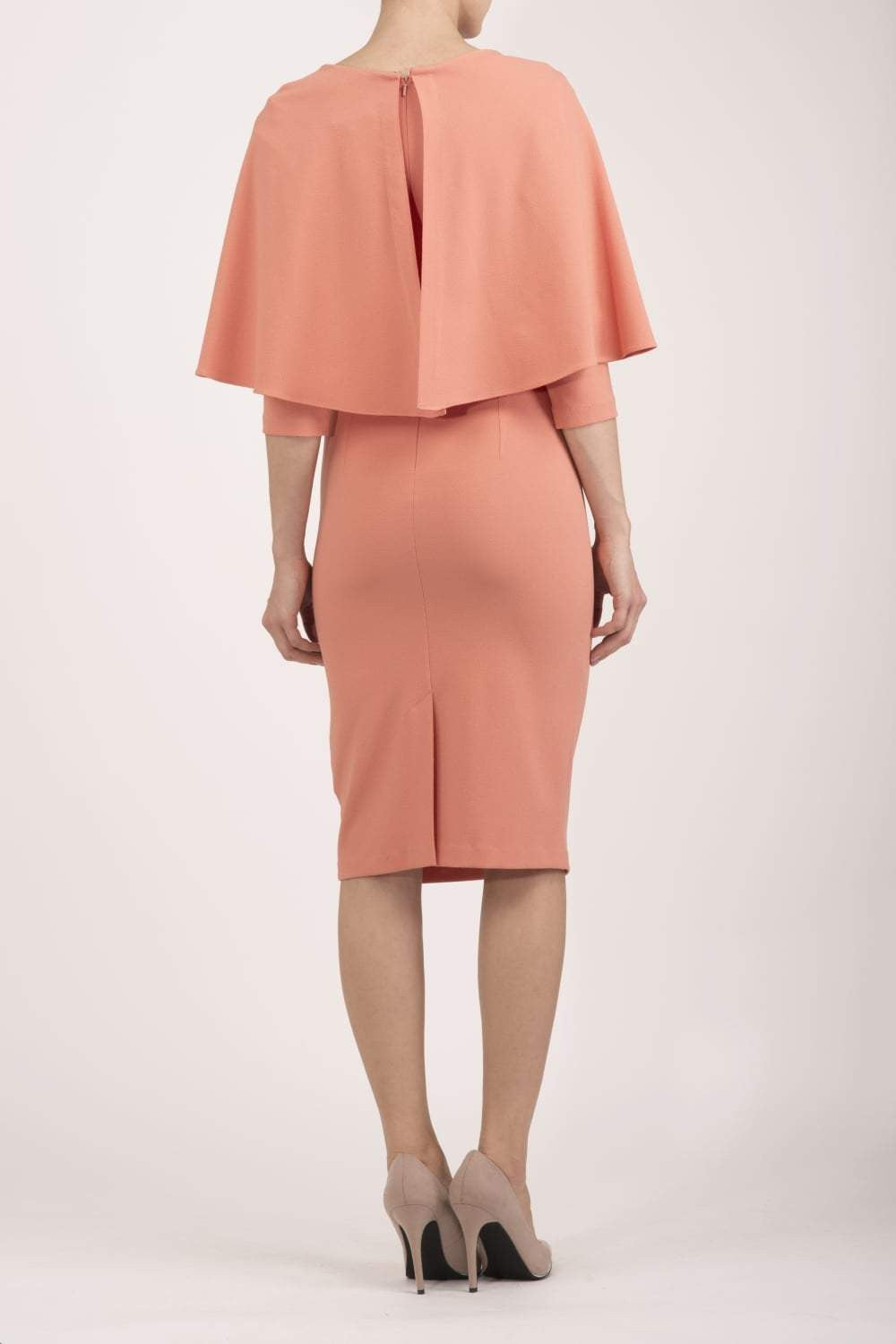 model wearing diva catwalk lizanne pencil-skirt dress with an attached wide cape detail and 3 4 sleeves in colour peach back