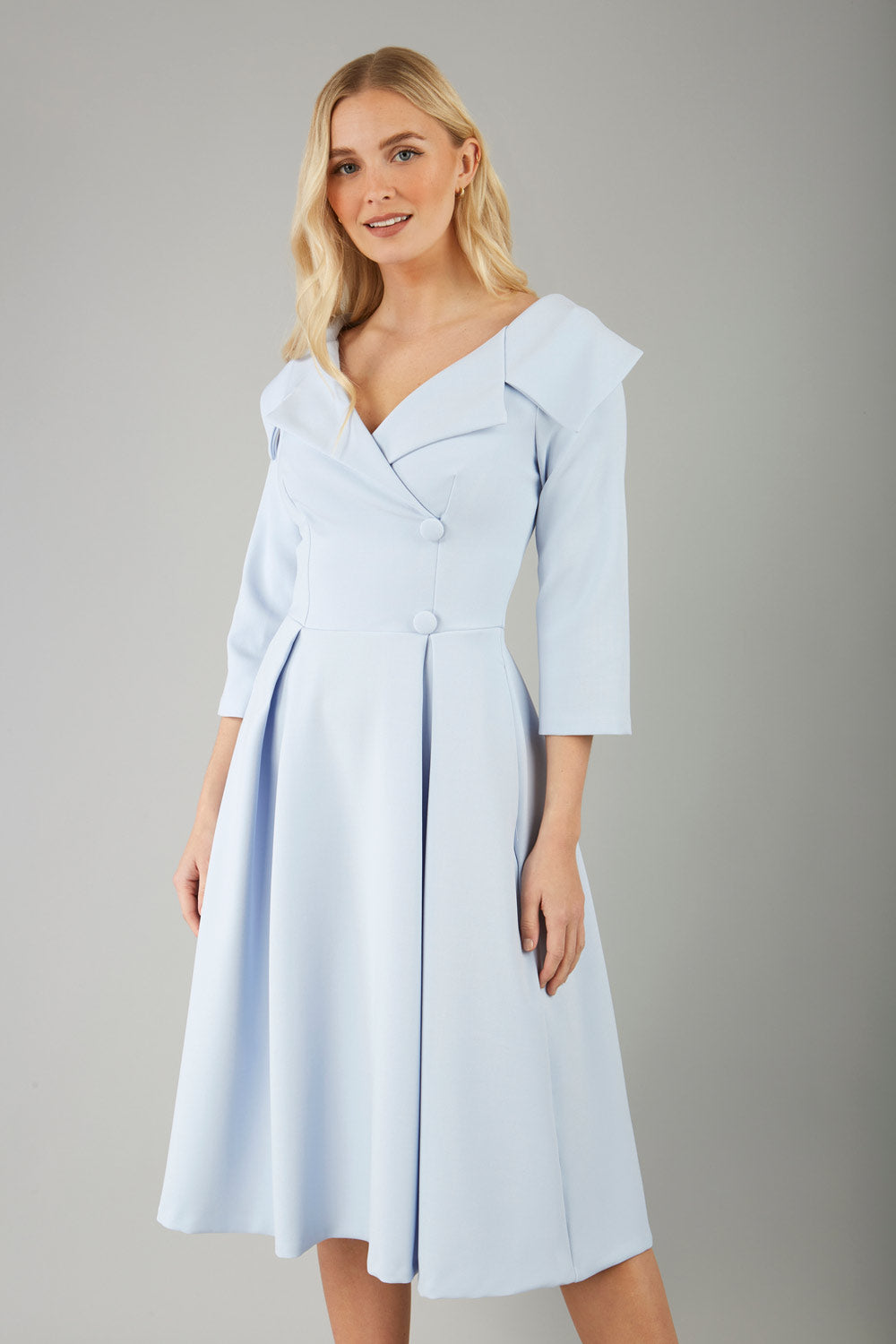 model is wearing diva catwalk gatsby swing dress with pocket detail and wide v-neck collar and buttons down the front panel in celestial blue front