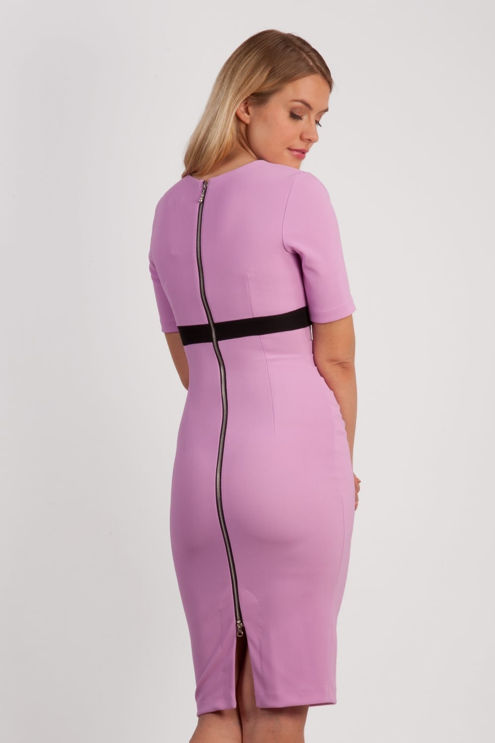 brunette model wearing diva catwalk nadia fitted dress with pencil pleated skirt with sleeves and rounded neckline with split in colour pearl violet front